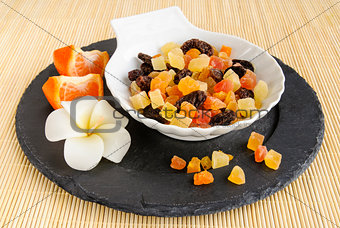 Dried fruits on stone plate with flower