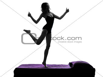  woman happy thumb up standing on bed silhouette