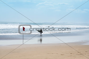 surfer walking kuta beach bali