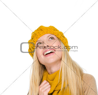 Portrait of smiling girl in autumn clothes looking up on copy sp