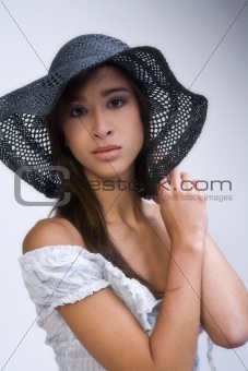 Mixed raced young beauty with her hat