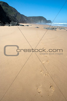 Foot prints in the sand on Cordama Beach, Portugal