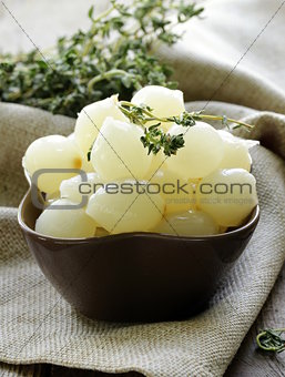 small pickled pearl onions on a wooden table