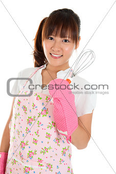 Asian girl holding egg beater 