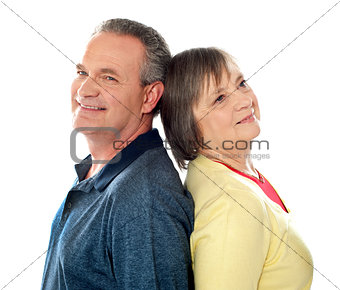 Closeup shot of aged couple, back to back