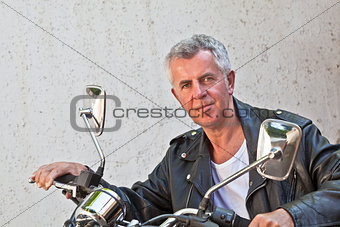  Weather beaten face Rider sat on a Motorcycle