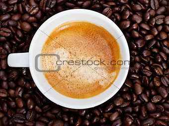 espresso cup in coffee beans
