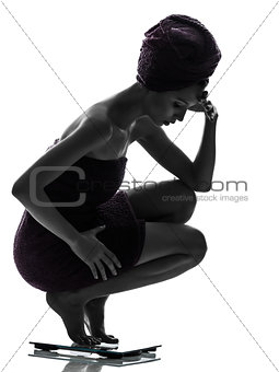 beautiful asian young woman worried on weight scale silhouette