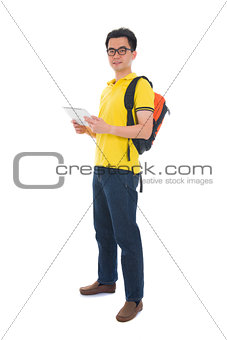 asian male student holding a tab and bag with isolated white bac