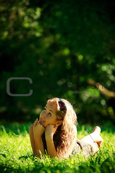 girl laying on sunny meadow