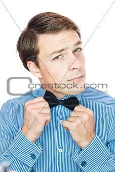 Handsome old-fashioned gentleman adjusting his bow tie 