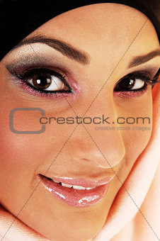 Closeup of smiling girl with headscarf.