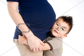 Firstborn Child Boy Hugs Mothers Pregant Belly Ready for Sister