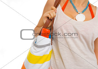 Closeup on sun block creme in bag of beach woman