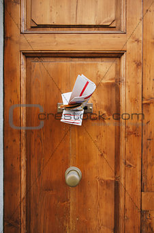 Magazines in a letterbox of a door