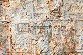 A weathered natural sandstone brick wall