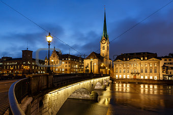 Illuminated Fraumunster Church and River Limmat in Zurich, Switz