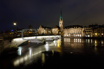 Illuminated Fraumunster Church and River Limmat in Zurich, Switz