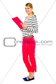 Woman standing with clipboard