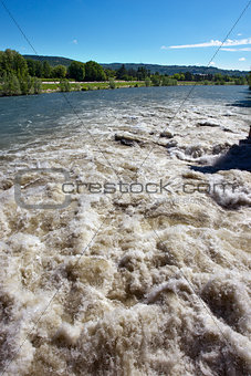 Brown River Rapids and Blue Sky