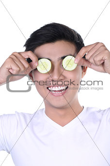 Asian Man with cucumber slices on eyes