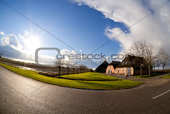 sun over Dutch farm house, fisheye view