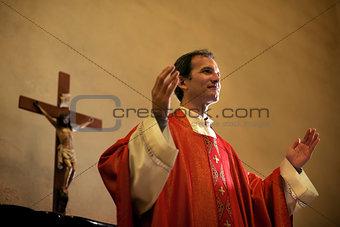 Catholic priest on altar praying during mass