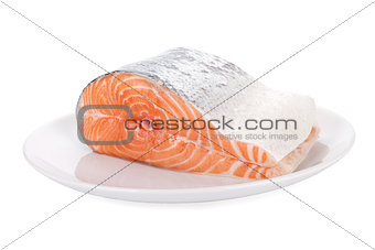 Raw steak of salmon on white plate isolated