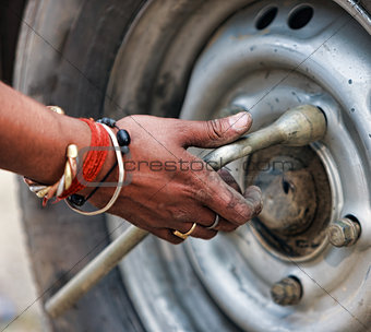 Man changing the car wheel on the road,  close up