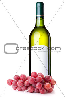 White wine in green bottle and grapes branch