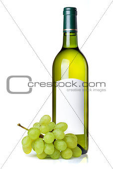 White wine in green bottle with blank label and grapes