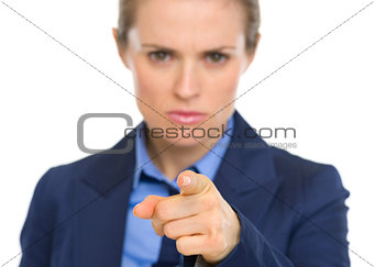 Closeup on concerned business woman pointing in camera