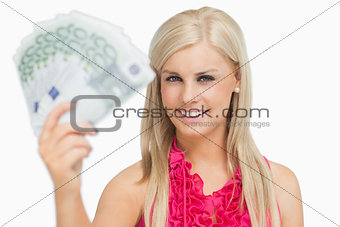 Fair hair woman holding 100 euros banknotes