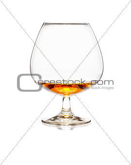 Glass of cognac or whiskey isolated on white background