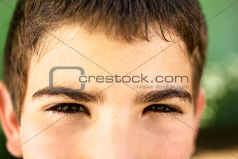 Portrait of serious young boy staring at camera