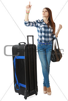 A young girl with a big, black travel bag on wheels, looks timet