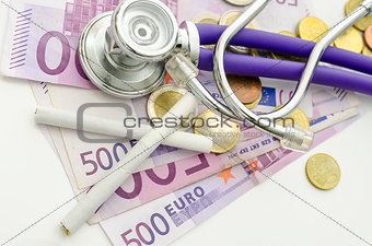Top view of ciarettes and stethoscope on Euro money