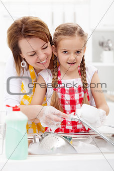 Little girl washing dishes