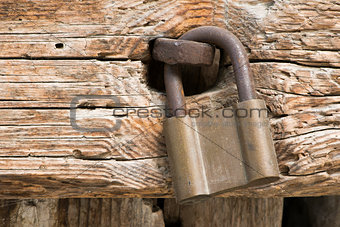 Old rotten board with padlock