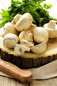 fresh mushrooms (champignons) on a wooden table