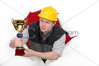 craftsman holding a golden cup