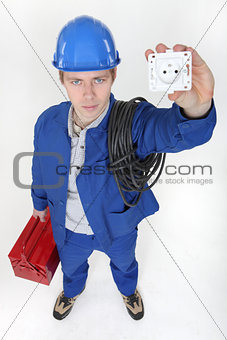 high angle shot of young electrician showing socket