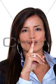 Businesswoman gesturing for silence