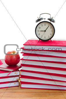 alarm clock and books on a table