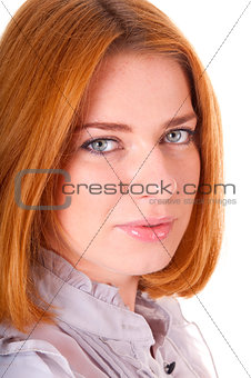 Smiling red-haired young woman in blouse and skirt
