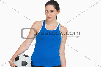 Serious sportswoman with a soccer ball