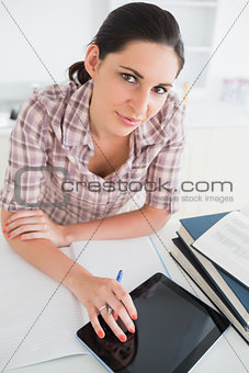 Woman using an ebook while looking at camera