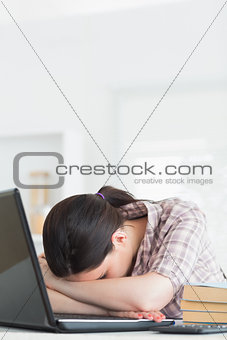 Woman leaning on the table next to a computer