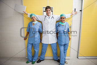 Happy doctor between two smiling nurses