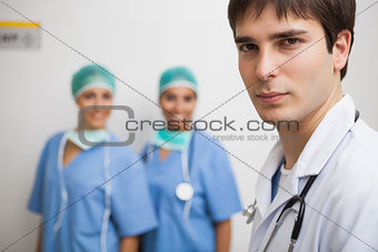 Satisfied doctor with two nurses